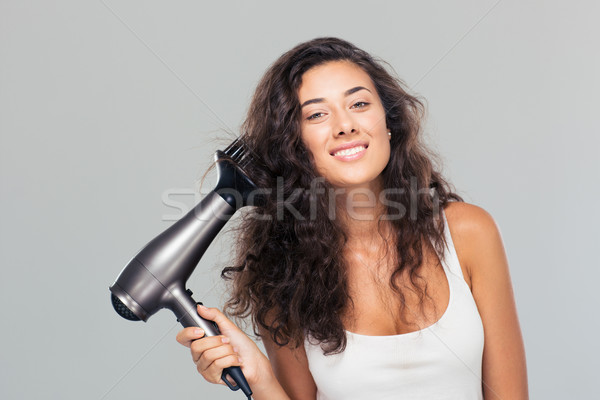 Portrait of a happy cute woman dries her hair  Stock photo © deandrobot