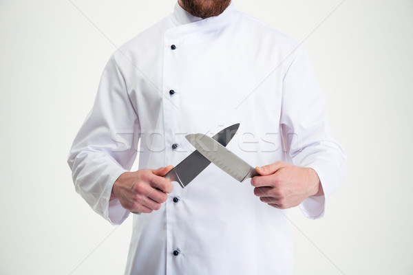 Closeup portrait of a male chef cook sharpening knife  Stock photo © deandrobot