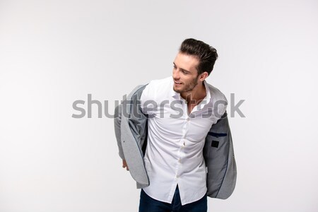 Portrait of a happy businessman dressing jacket Stock photo © deandrobot