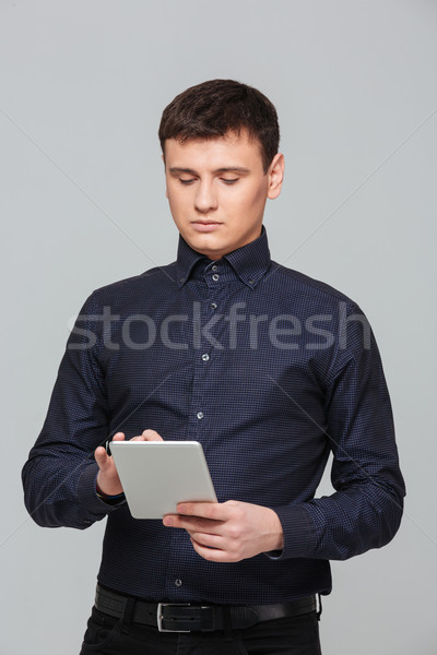 Businessman using tablet computer Stock photo © deandrobot
