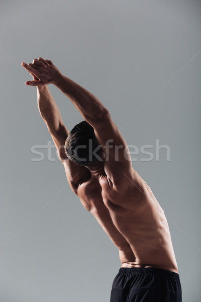 Fitness man doing stretching exercises Stock photo © deandrobot