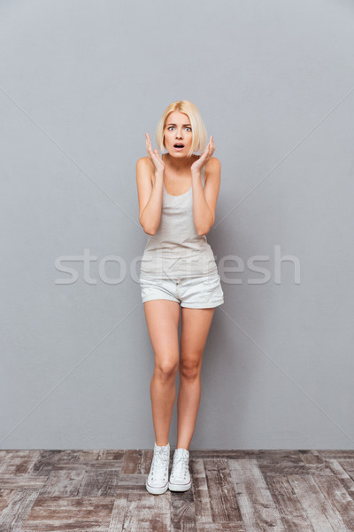 Ijedt fiatal nő áll száj kinyitott szürke Stock fotó © deandrobot