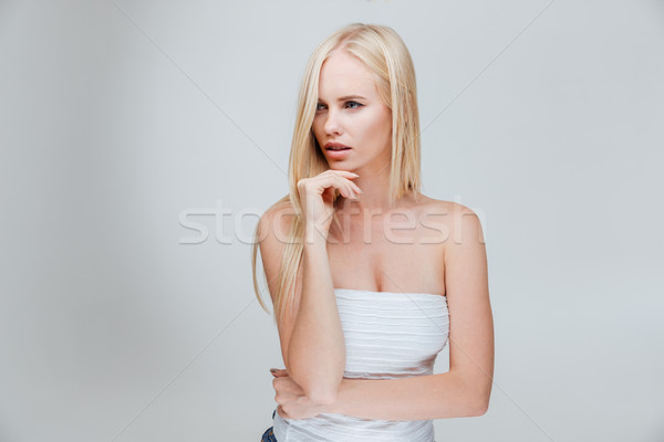 Portrait of a pensive pretty blonde girl thinking about something Stock photo © deandrobot