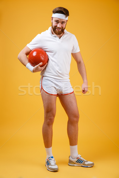 Lächelnd jungen Sportler halten Ball schauen Stock foto © deandrobot