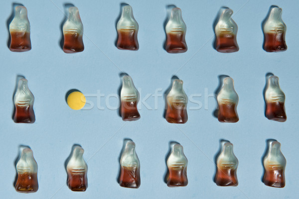 Candy in bottle form over blue table background. Stock photo © deandrobot