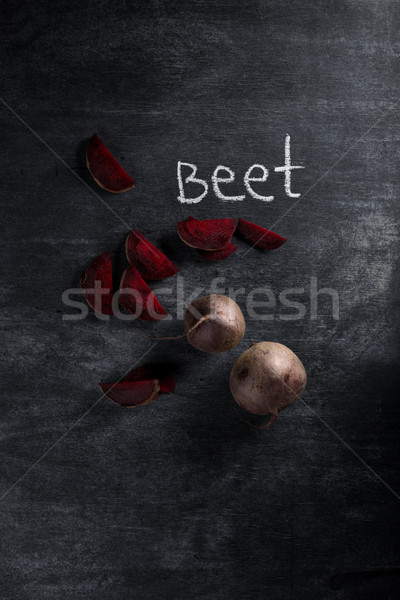 Cut beet over dark chalkboard background Stock photo © deandrobot