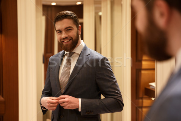  Smiling man looking at the mirror Stock photo © deandrobot