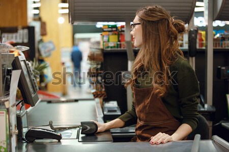 Derűs pénztáros nő munkaterület áruház bolt Stock fotó © deandrobot