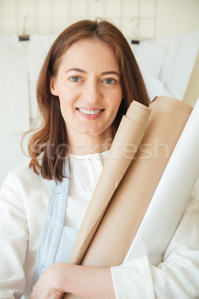 Mosolygó nő tart tekercsek papír portré mosolyog Stock fotó © deandrobot