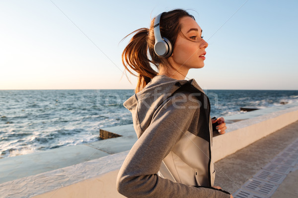 Close-up portrait of pretty running sport woman, seaside outdoor Stock photo © deandrobot
