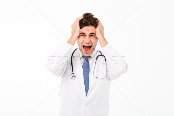 Portrait of a furious mad male doctor with stethoscope Stock photo © deandrobot