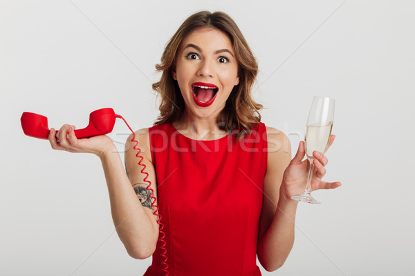 Stock photo: Portrait of a happy young woman dressed in red dress