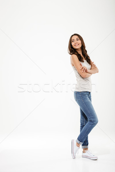 Full length image of Pleased brunette woman posing sideways Stock photo © deandrobot