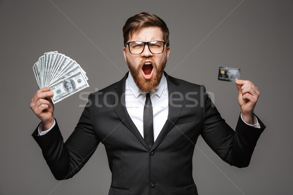Portrait of a shocked young businessman Stock photo © deandrobot