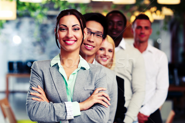 Happy group of business people in the office lined up Stock photo © deandrobot