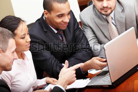 Multi ethnic business team at a meeting. Focus on african-american man Stock photo © deandrobot