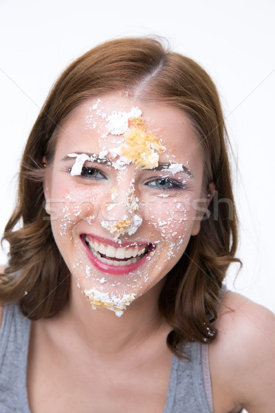Happy young woman with cake at her face Stock photo © deandrobot