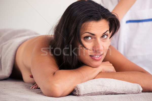 Happy woman lying on massage lounger Stock photo © deandrobot