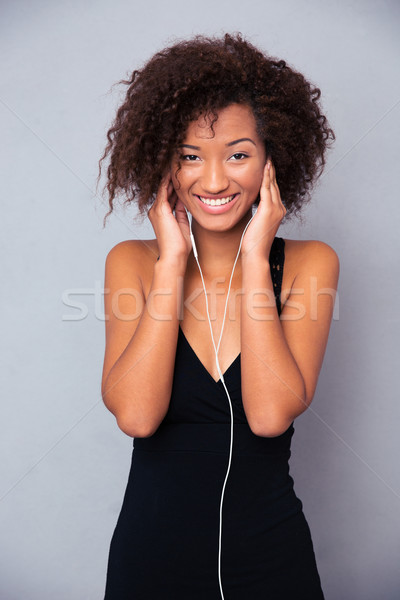 Afro american woman with headphones  Stock photo © deandrobot