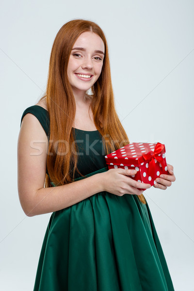 Happy woman in dress holding gift box Stock photo © deandrobot