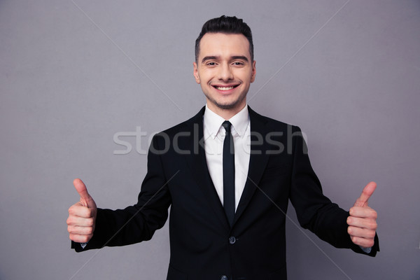 Stock photo: Smiling businessman showing thumbs up