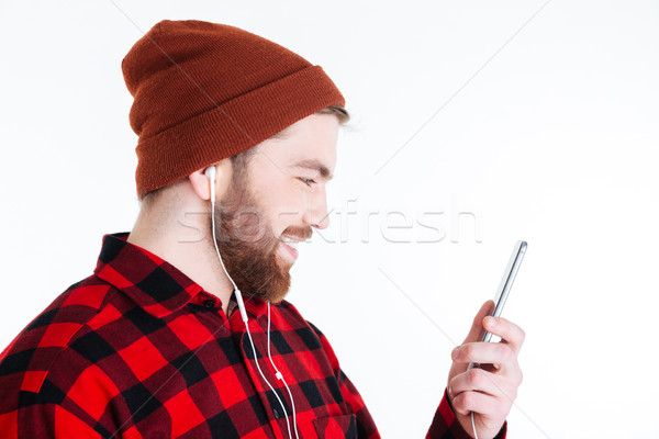 Close-up portrait of man with earphones and holding mobilephone Stock photo © deandrobot