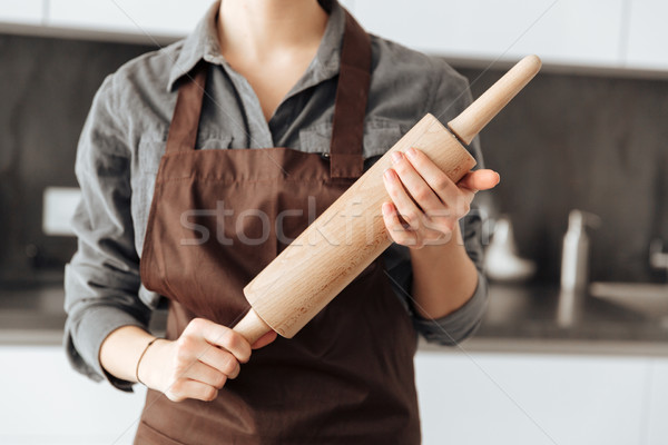 Cropped image of young woman standing in kitchen Stock photo © deandrobot