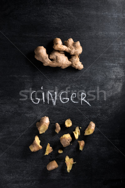 Photo of a ginger over dark chalkboard background Stock photo © deandrobot