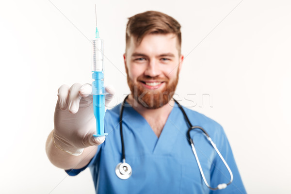 Portrait of a happy attractive medical doctor or nurse Stock photo © deandrobot