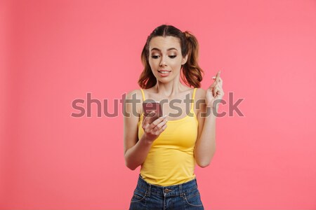 Girl in beachwear holding glass bottle and looking at camera Stock photo © deandrobot
