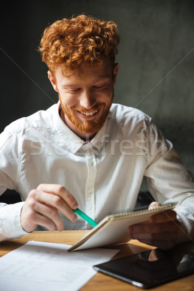 Close-up portrait of handsome smiling student studying at home Stock photo © deandrobot