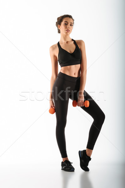 Full length image of beauty fitness woman posing with dumbbells Stock photo © deandrobot