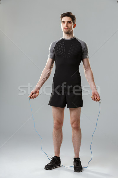 Full length portrait of a concentrated young sportsman Stock photo © deandrobot