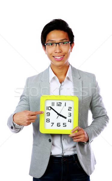 Business time. Business man holding and pointing to a big clock. Stock photo © deandrobot