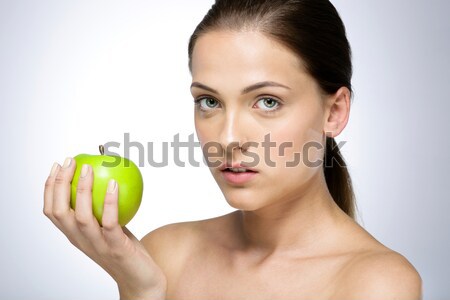 Portrait of a cute woman holding green apple Stock photo © deandrobot