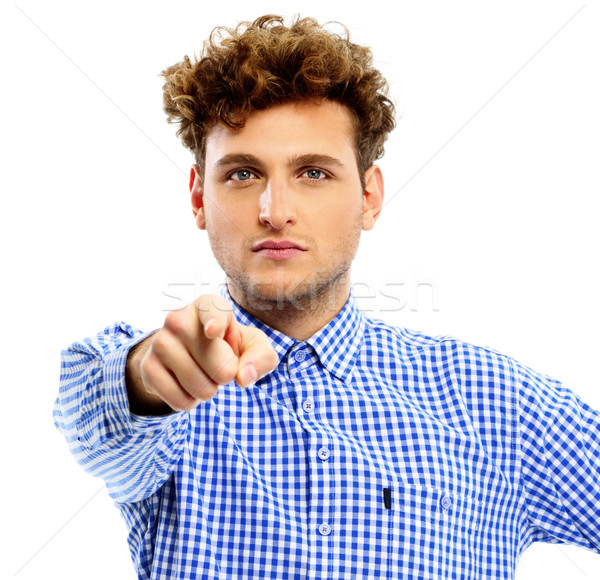 Young man pointing at you over white background Stock photo © deandrobot