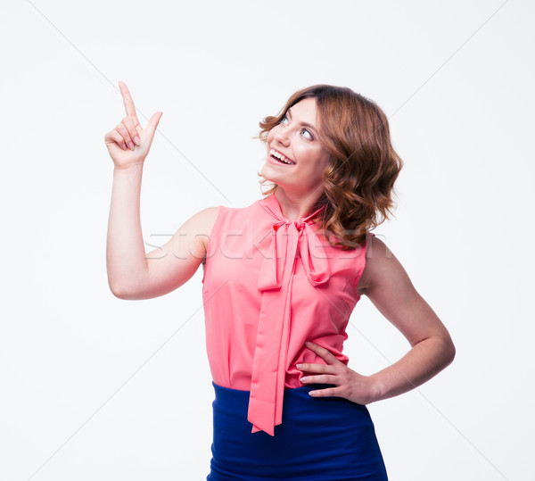 Szczęśliwy przypadkowy kobieta wskazując palec w górę Zdjęcia stock © deandrobot