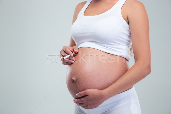 Mulher grávida fumador cigarro retrato isolado Foto stock © deandrobot