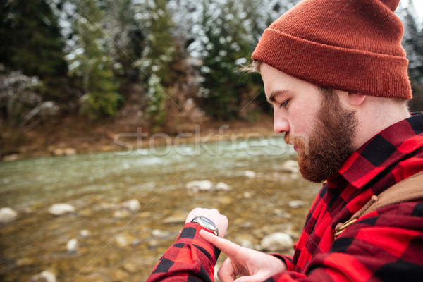 Man looking on the wrist watch outdoors Stock photo © deandrobot