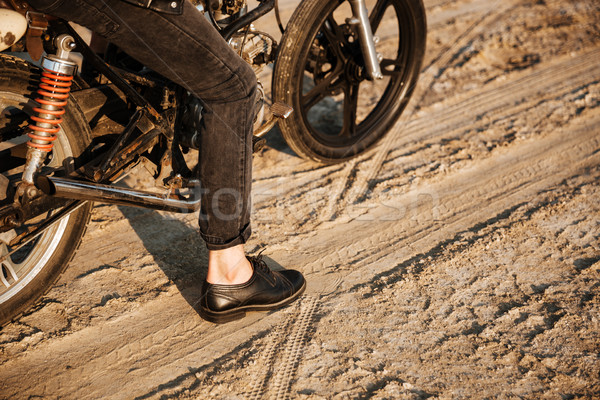 Cropped image of young brutal man driving retro motorcycle Stock photo © deandrobot