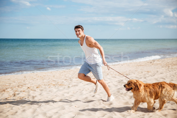 Stockfoto: Man · lopen · hond · strand · gelukkig · jonge · man