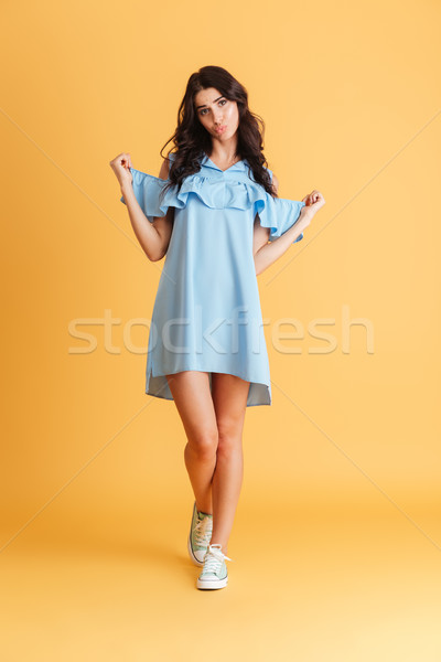 Full length portrait of a woman posing in blue dress Stock photo © deandrobot