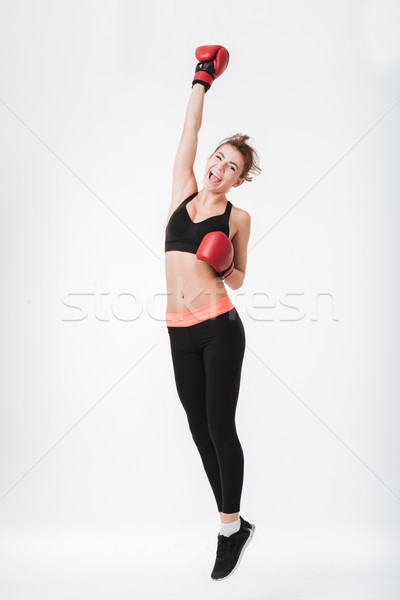 Pretty young boxer woman jumping Stock photo © deandrobot