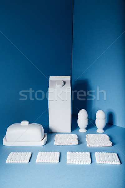 White pack of milk, eggs, butter, cookies and bread slices Stock photo © deandrobot