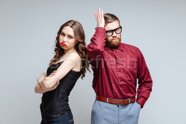 Displeased woman with male nerd Stock photo © deandrobot