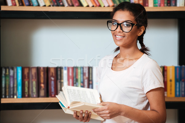 Young cheerful african woman wearing glasses Stock photo © deandrobot