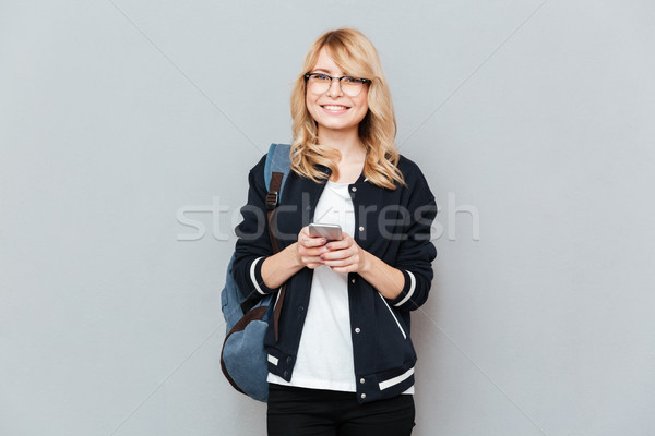 Student with phone looking camera Stock photo © deandrobot