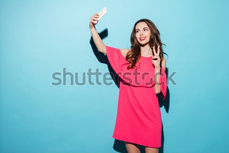 Happy young brunette woman pointing catch the car Stock photo © deandrobot
