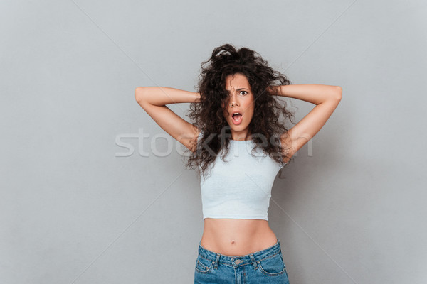 Angry displeased woman looking camera with opened mouth Stock photo © deandrobot