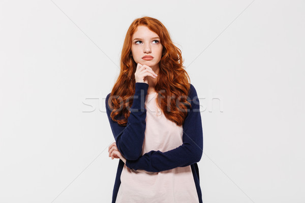 Thoughtful young redhead lady. Looking aside. Stock photo © deandrobot